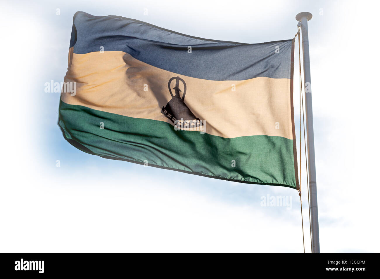 blur in lesotho waving national flag in the cloudy sky Stock Photo - Alamy
