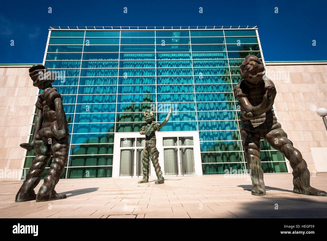 Germany, Essen, bronze sculptures  in front of the glas foyer of the Philharmonie, Saalbau. Stock Photo