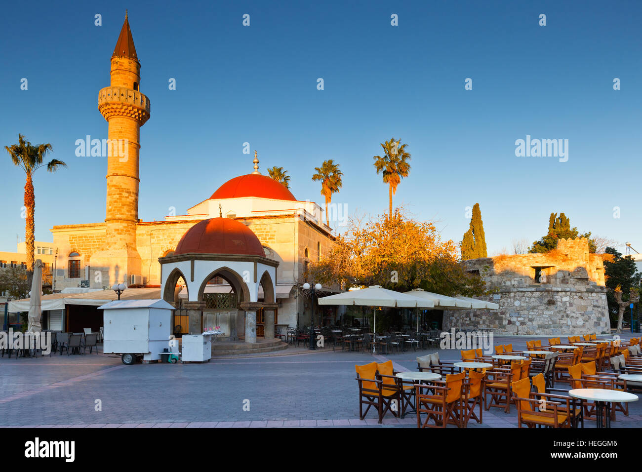 Mosque and coffee shops in the main square of the Kos town. Stock Photo