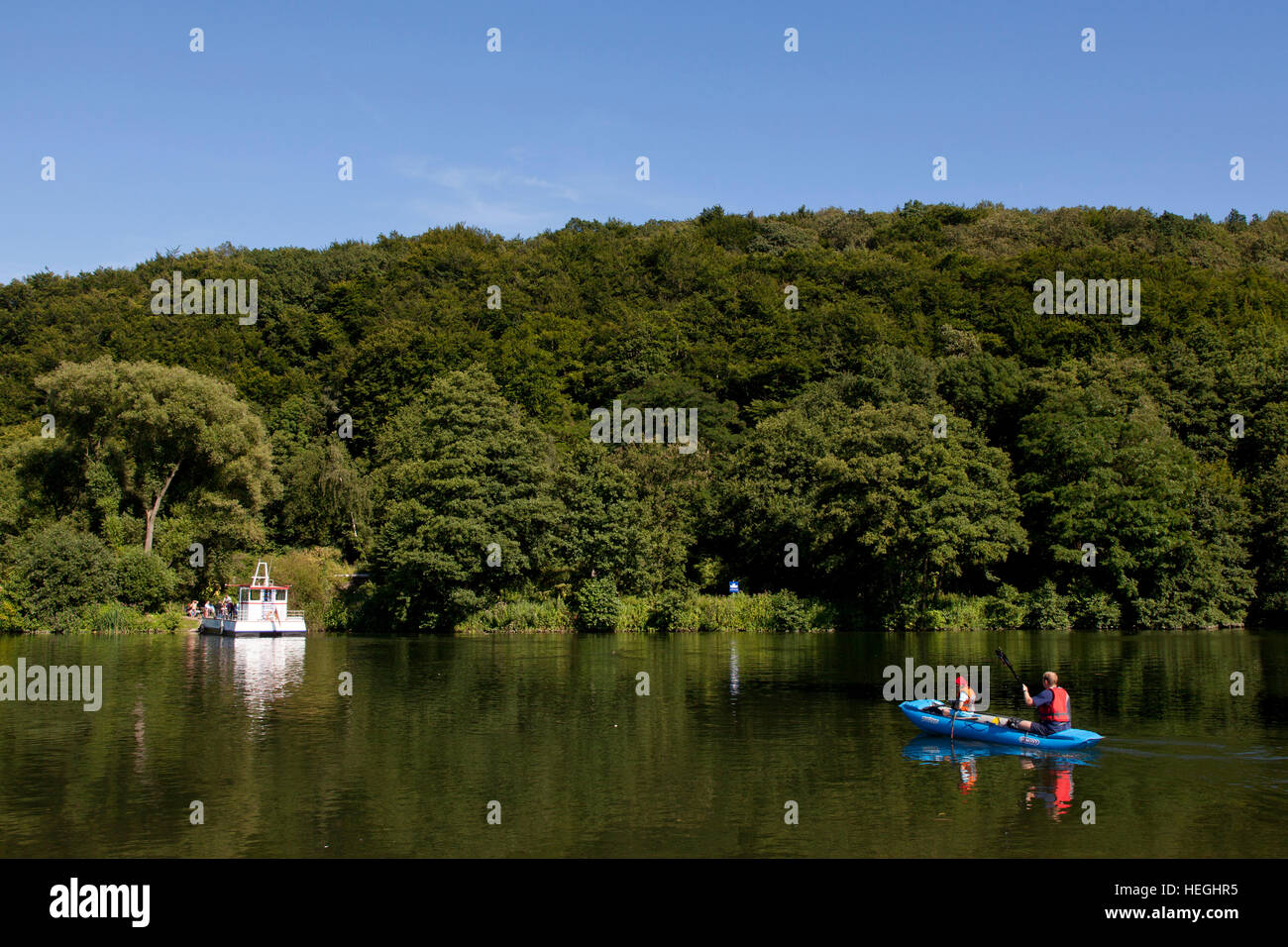 Germany, Ruhr Area, Witten, rubber dinghy and ferry boat on the river Ruhr in the district Herbede. Stock Photo