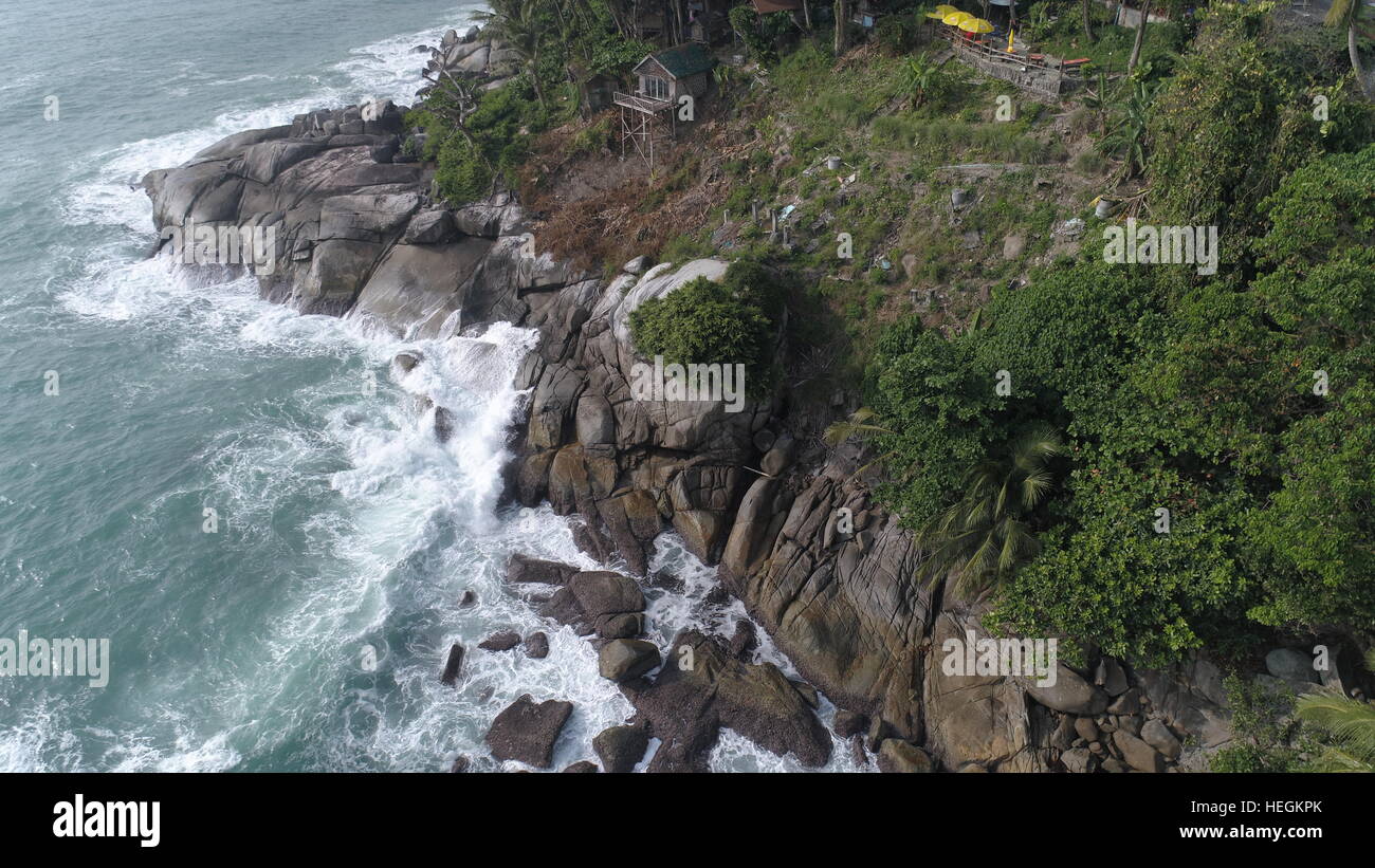 Aerial top view of sea waves hitting rocks on the beach in Phuket ...