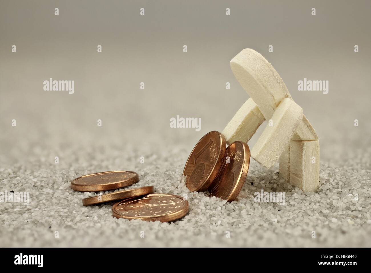Poor wooden male turn every cent twice Stock Photo