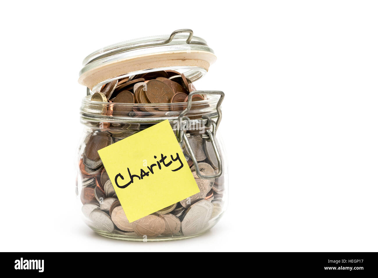 Jar of British coins collected for a charity - isolated on white background Stock Photo