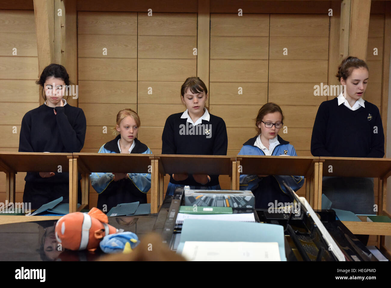 Choristers rehearse for one hour every school day before school starts, photographed in the song school at Wells Cathedral. Stock Photo