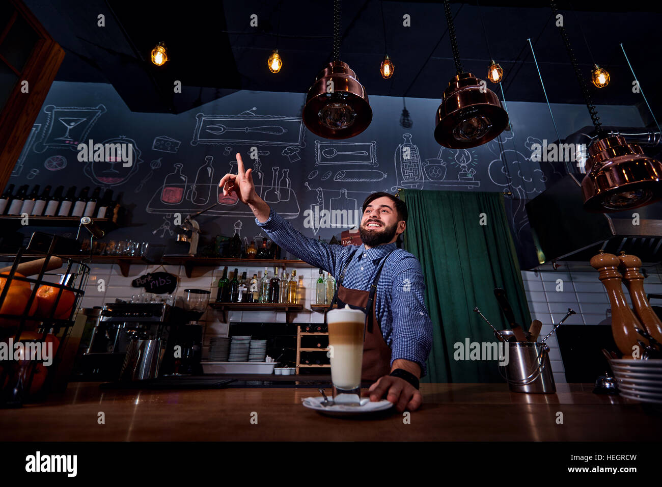 Barman barista in uniform making coffee tea, cocktails Stock Photo