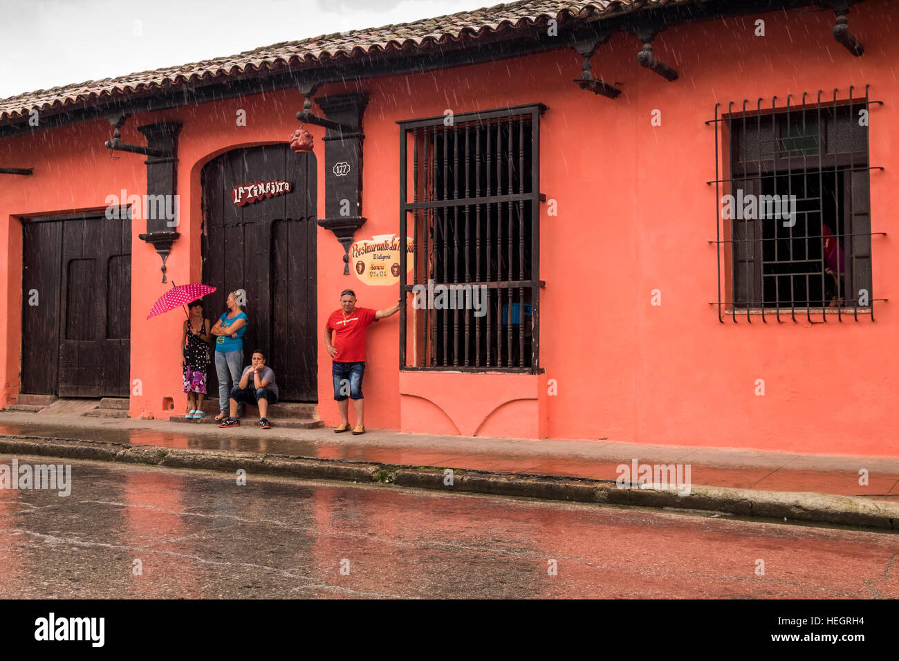 Sheltering from a rain shower in Camaguey, Cuba Stock Photo