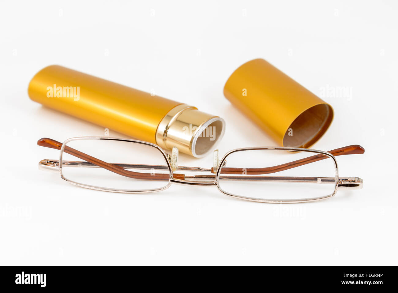 Glasses in gold case shot on white background Stock Photo