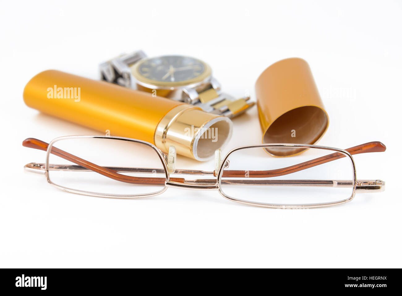 Glasses in gold case and watch shot on white background Stock Photo
