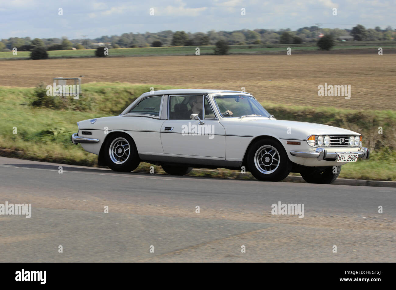 White Triumph Stag hardtop tracking action shot Stock Photo