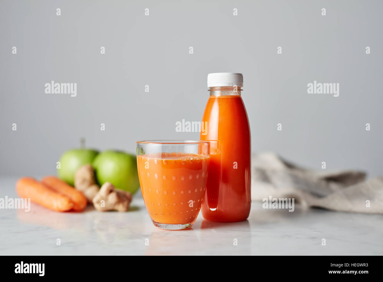 Carrot and Apple juice fresh healthy organic drinking glass plastic bottle Stock Photo