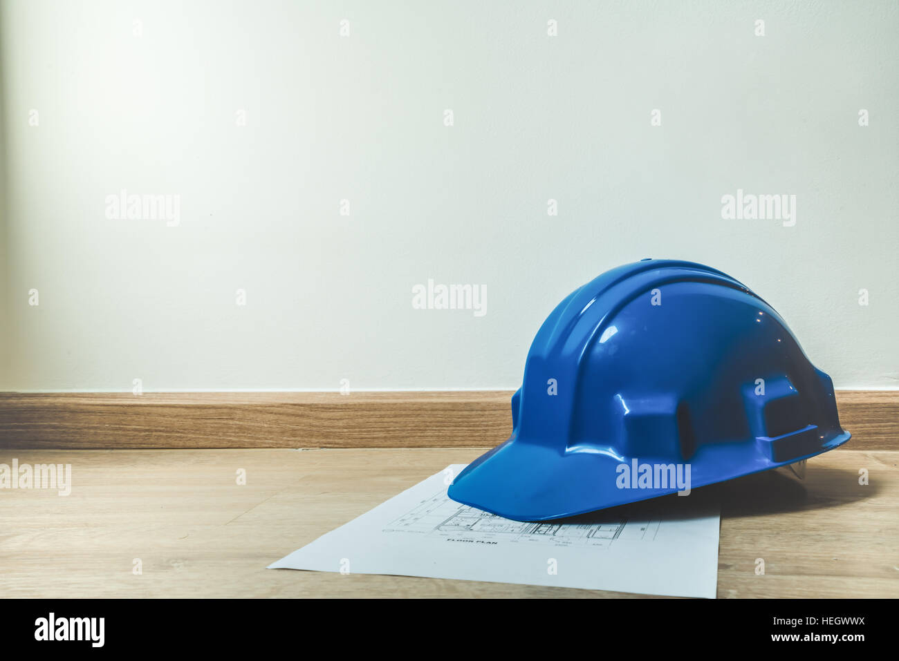 Safety blue helmet and home construction plan, architecture or construction or industrial equipments, with copy space, engineering concept, soft light Stock Photo