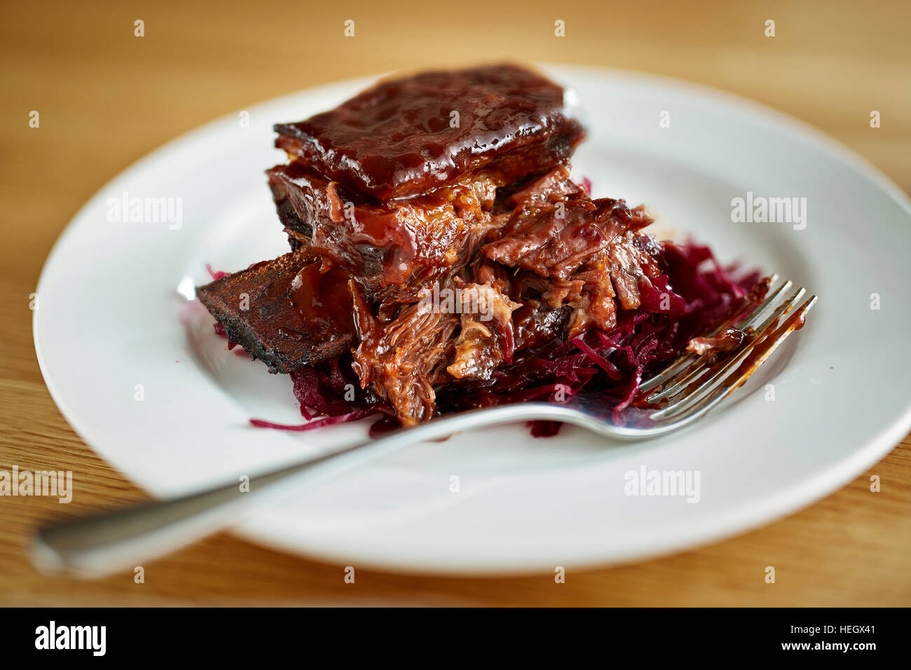 braised short rib beef gravy jus sauce fork meat feast Stock Photo