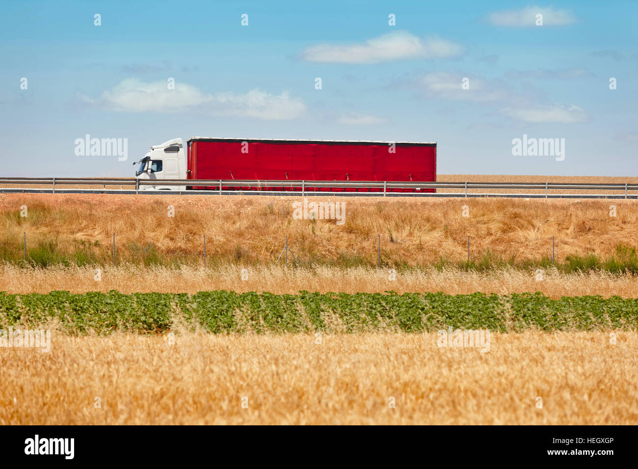Red heavy truck on the road. Delivery cargo logistic. Spain. Horizontal