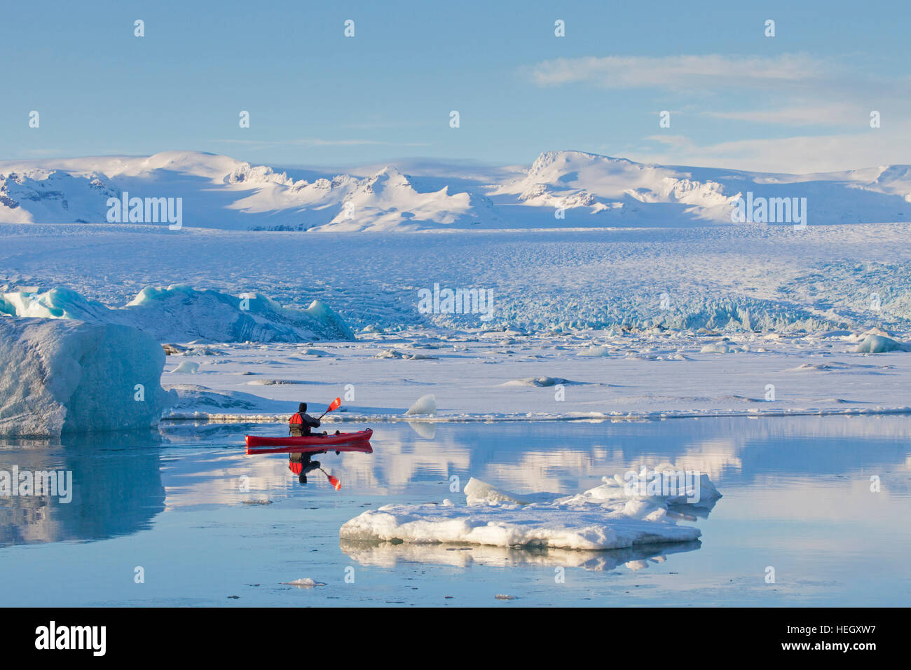 Kayaker in red kayak on the Jökulsárlón glacier lagoon in winter, glacial  lake in southeast Iceland Stock Photo - Alamy