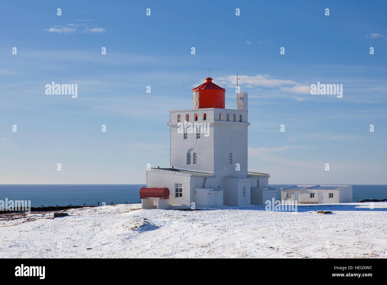 Dyrhólaey lighthouse at Vík í Mýrdal on the central south coast of Iceland in the snow in winter Stock Photo