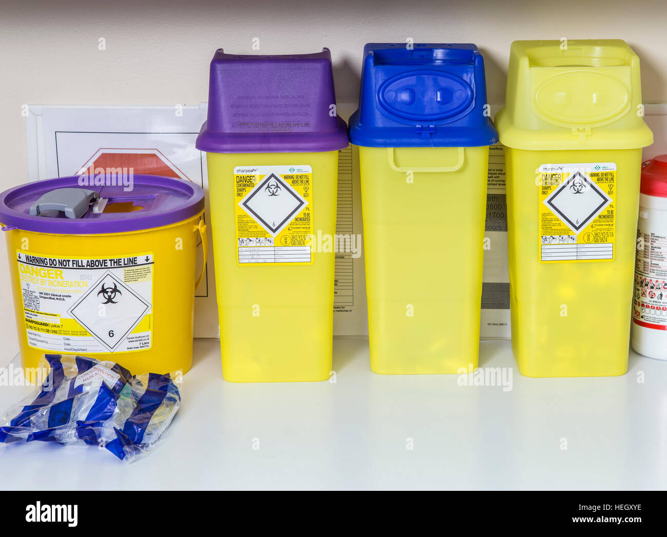 A selection of sharps containers on a bench in a doctors surgery Stock