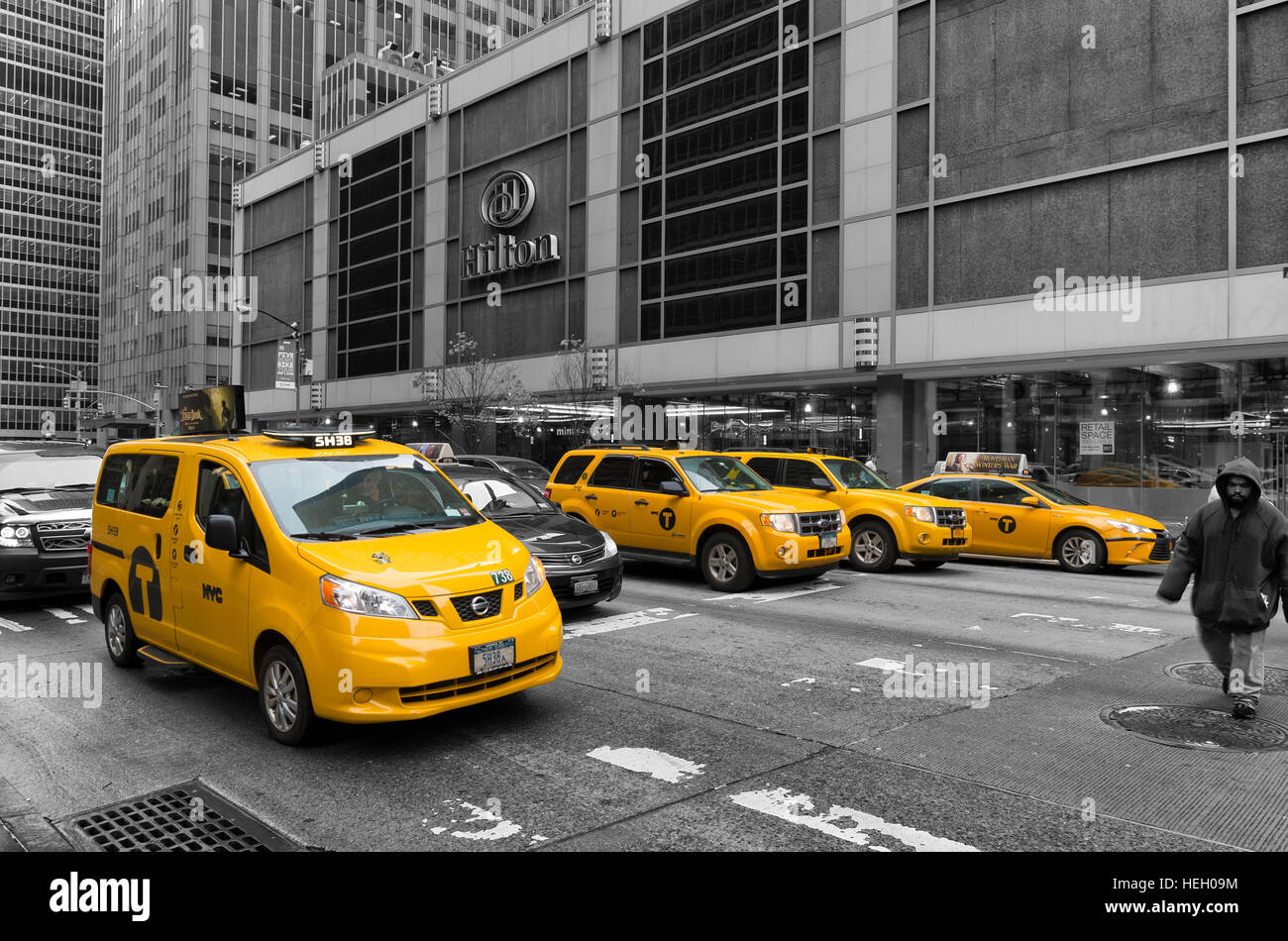 NEW YORK - MAY 3, 2016: Typically yellow medallion taxicabs in front of the New York Hilton. They are widely recognized icons of the city and come in Stock Photo