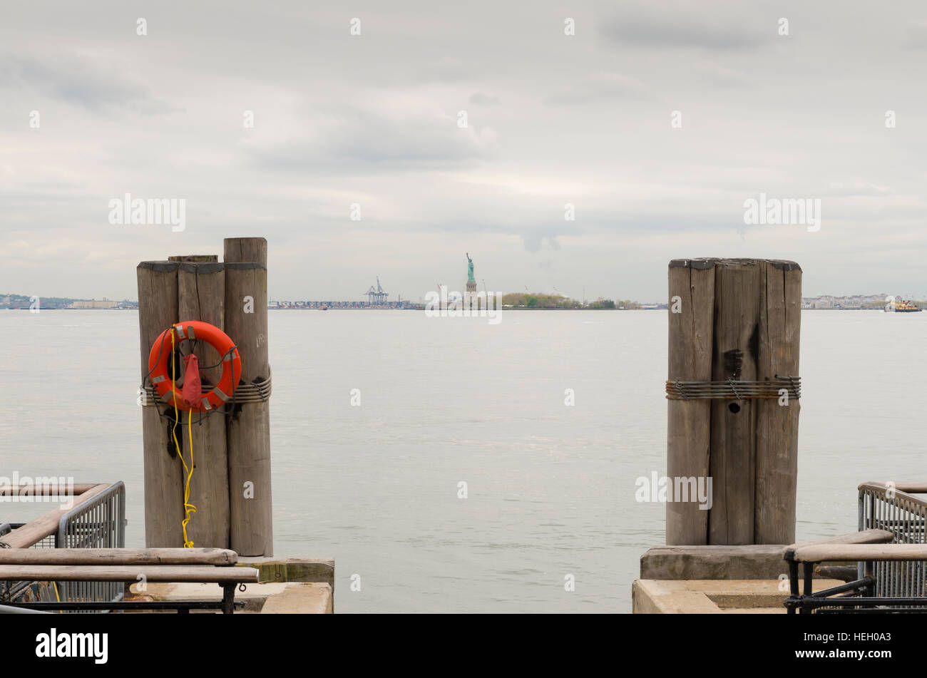 Statue of Liberty at the horizon seen from Battery park in lower Manhattan Stock Photo