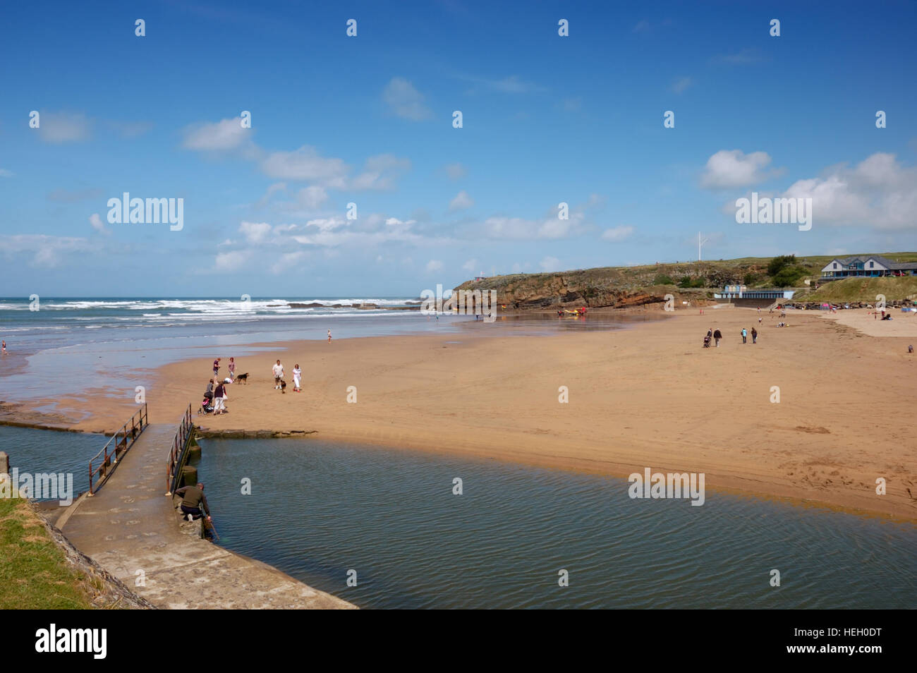 A footbridge across the River Neet or Strat at low tide looking across Summerleaze Beach in the Cornish town of Bude. Stock Photo
