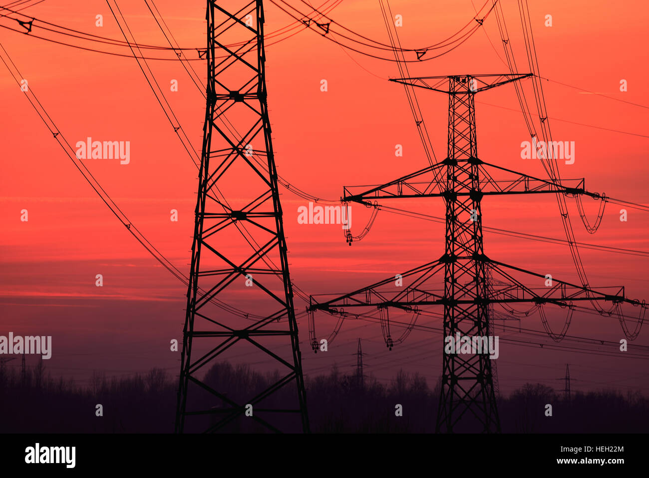 A pylon and highvoltage power lines, sunset, red sky Stock Photo Alamy