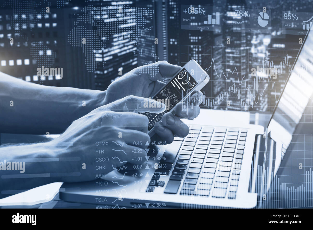 Double exposure of abstract financial graphs, business person in office using smartphone and laptop computer with stock market dashboard, and building Stock Photo