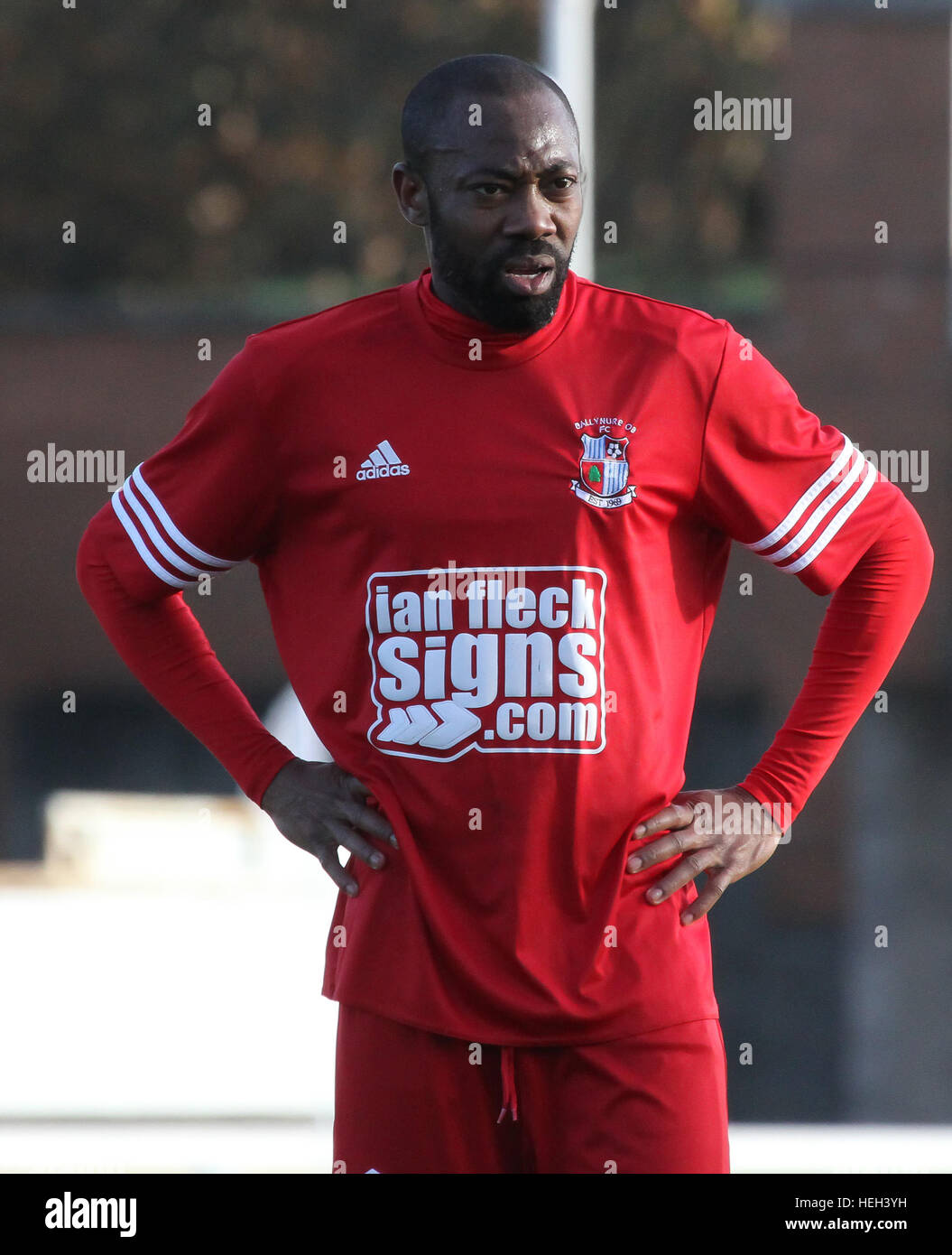 Former Nigerian International Kevin Amuneke (red) playing for Northern Ireland junior side Ballynure Old Boys in the Intermediate Cup against Lisburn Distillery in November 2016. On the 22nd December 2016 local media announced that Amuneke would be joining Irish Premier League side Linfield in the January 2017 transfer window. Stock Photo