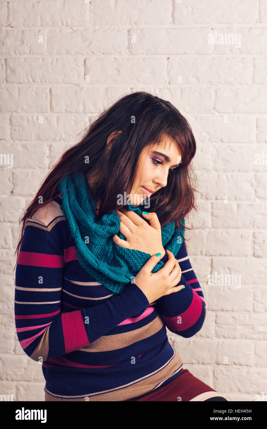 Cheerful young woman in scarf indoors Stock Photo