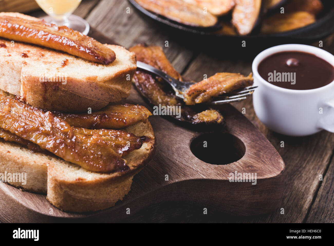 Homemade brioche sandwiches with bananas in buttery caramel sauce