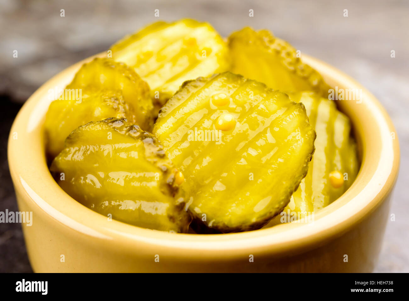 Fresh homemade pickled cucumber with mustard seeds in small ceramic bowl Stock Photo