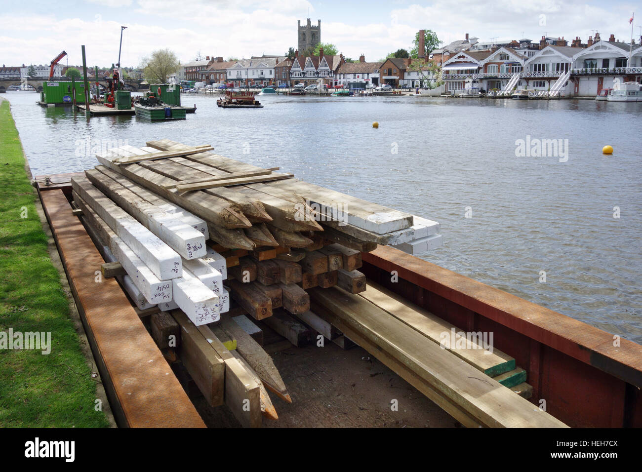 Wooden piles stacked in a barge in preparation for the annual regatta, Henley-on-Thames, Oxfordshire, England, UK Stock Photo
