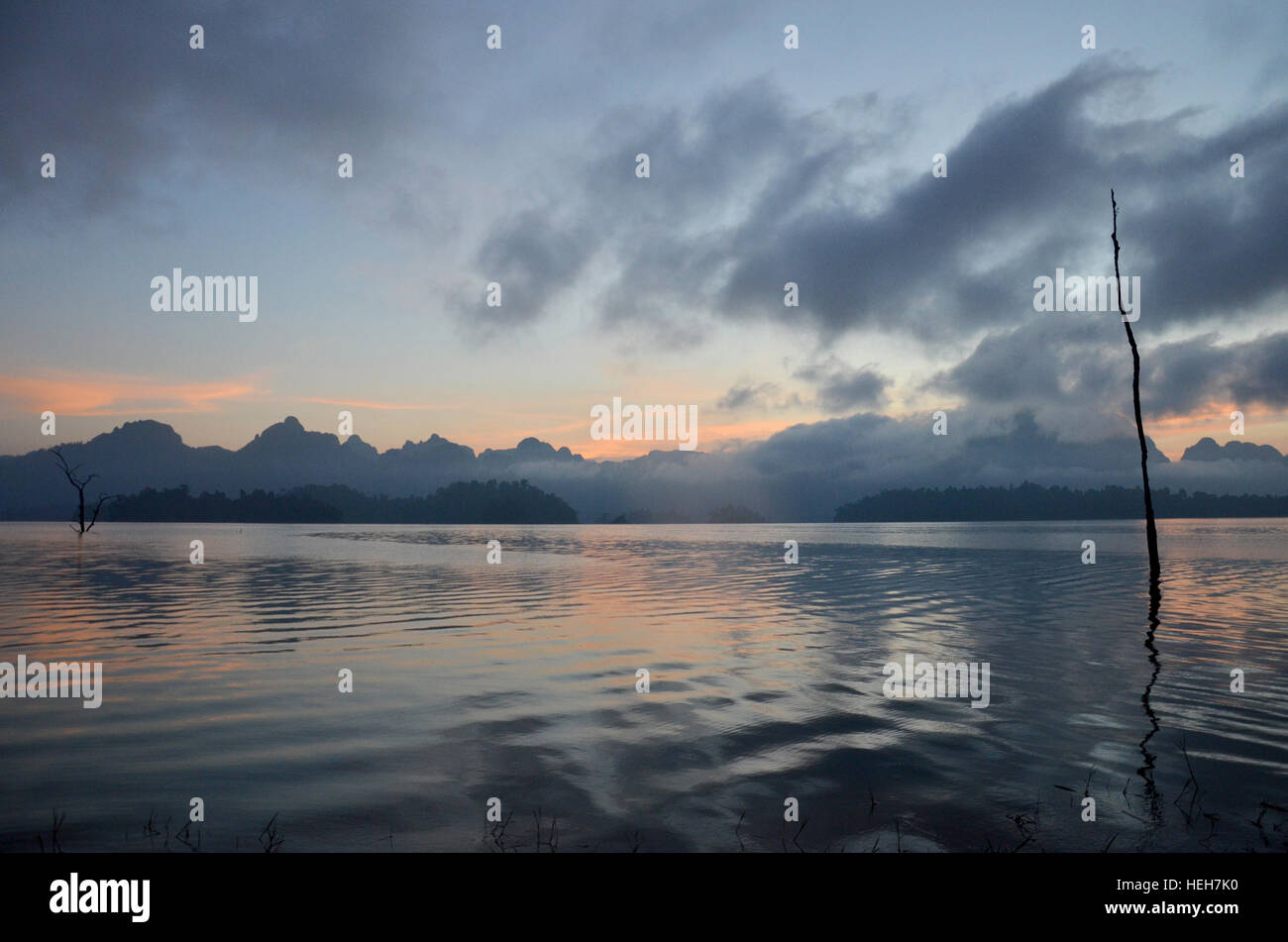 Sunrise with Limestone rocks mountain in morning time at Khao Sok Nation Park in Cheow Lan Lake at Ratchaprapa or Rajjaprabha Dam Reservoir in Surat T Stock Photo