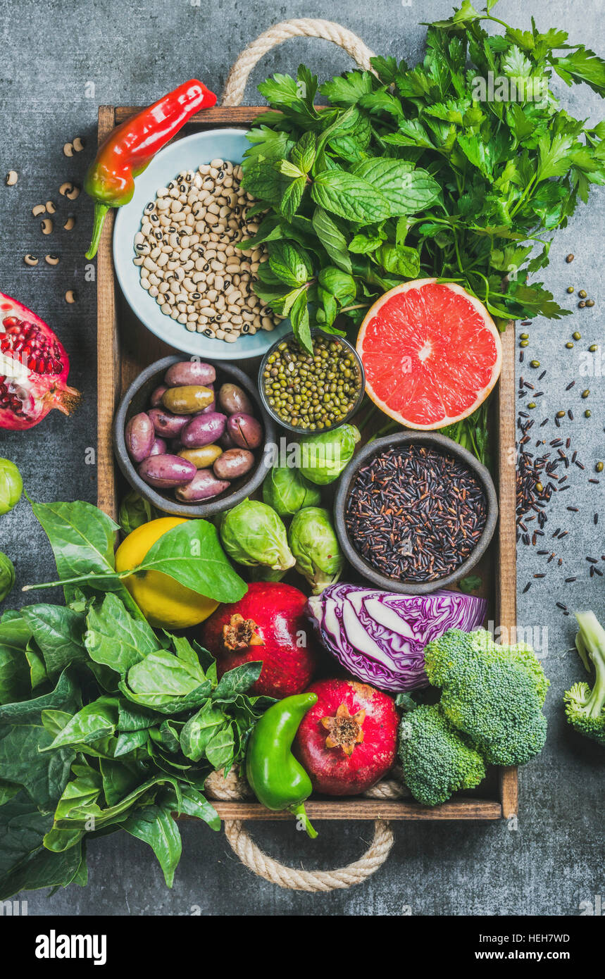 Fresh vegetables and fruits, seeds, cereals, beans, spices, superfoods, herbs, condiment in wooden box for vegan, allergy-friendly, clean eating and r Stock Photo