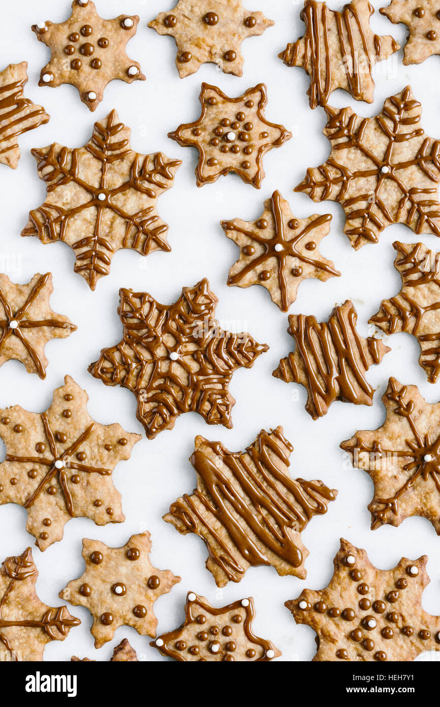 Decorated Snowflake cookies are photographed from the top view. Stock Photo