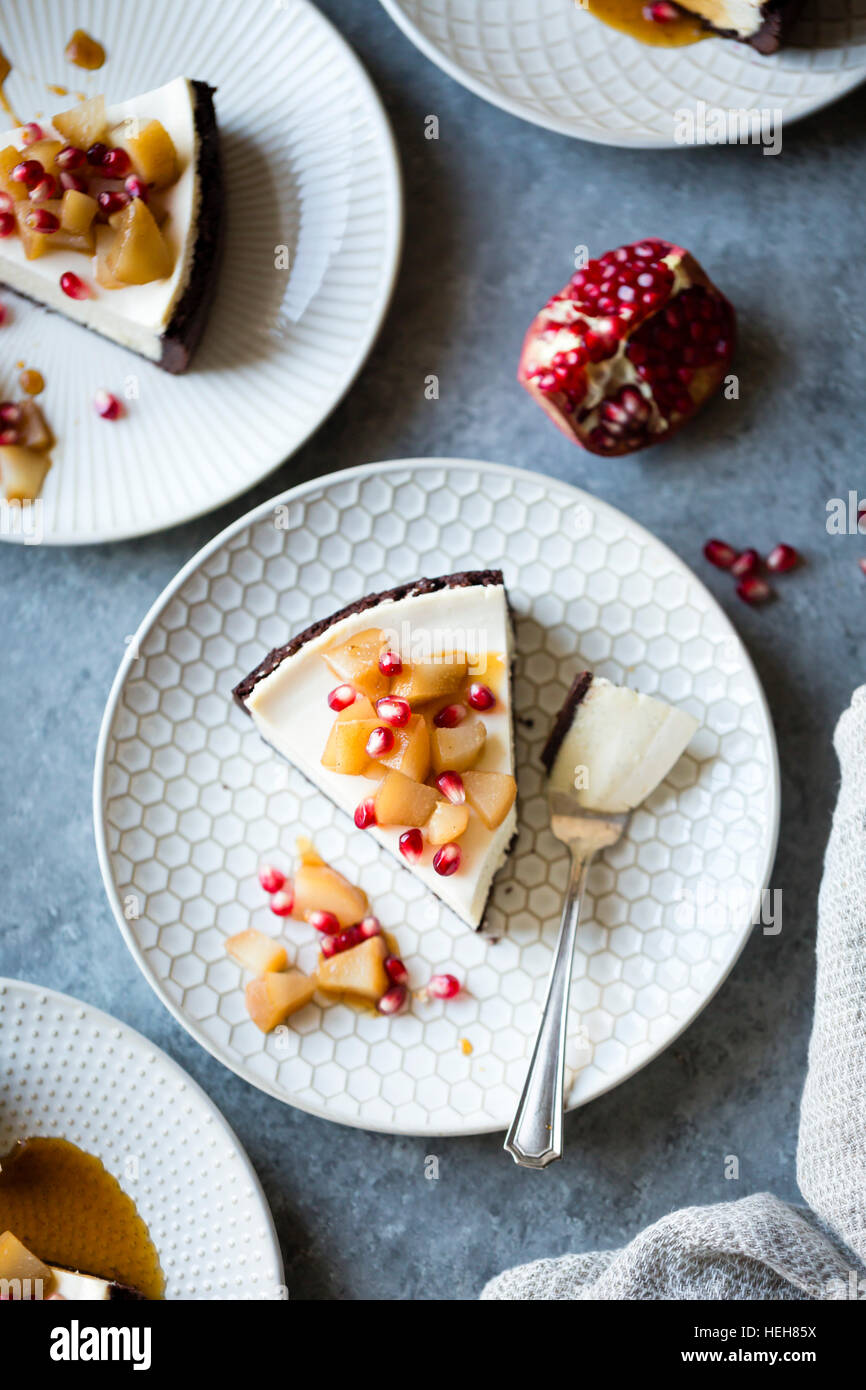 Chocolate Crusted Chèvre Cheesecake with Earl Grey Poached Pears & Pomegranate (gluten-free) Stock Photo