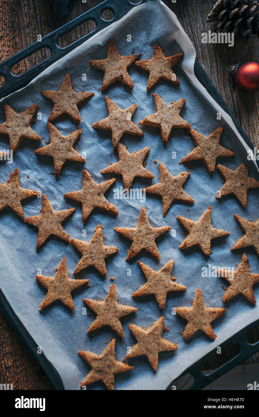 Almond cinnamon Christmas cookies on a baking tray Stock Photo