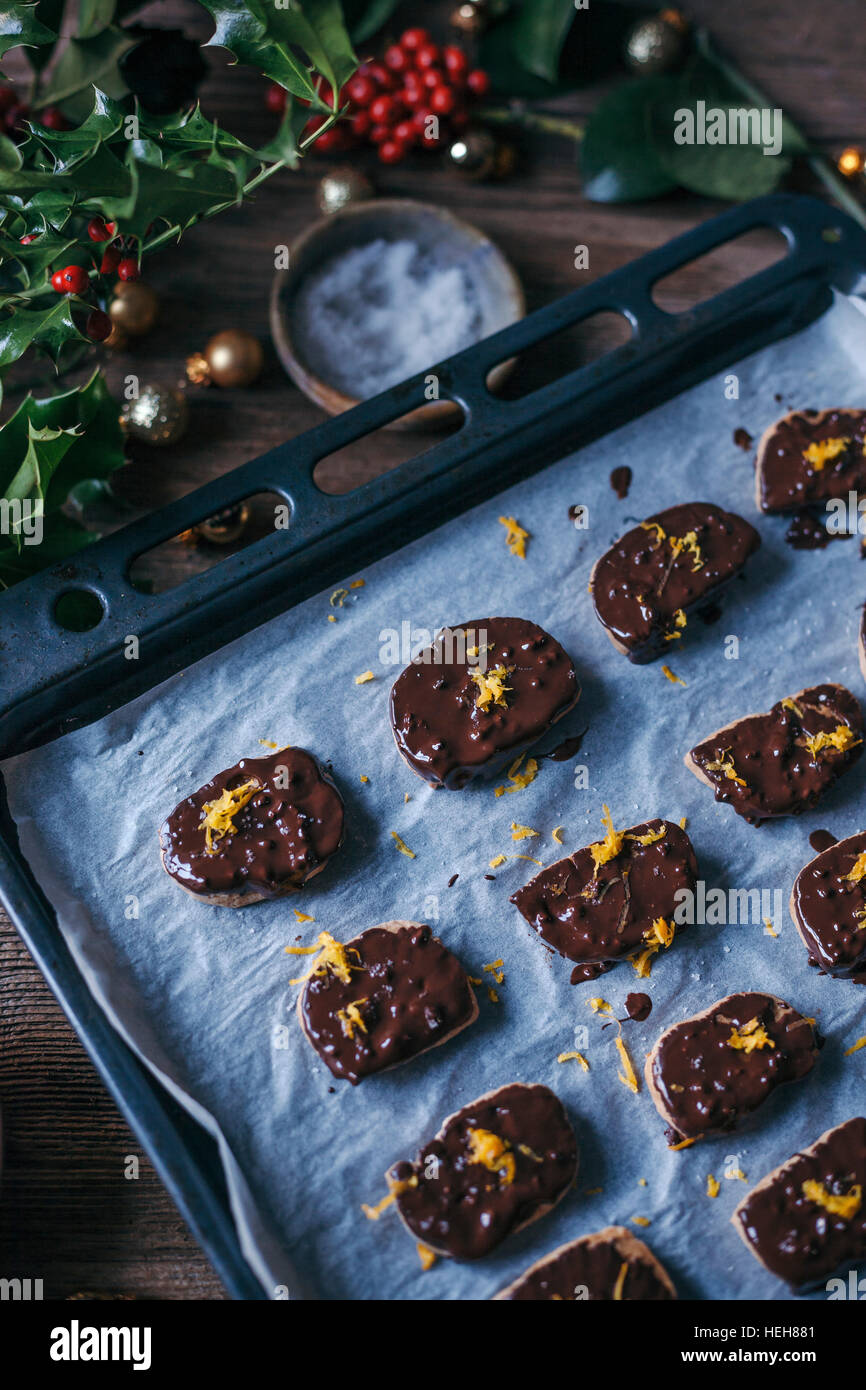 Dark chocolate and orange cookies on a baking tray Stock Photo