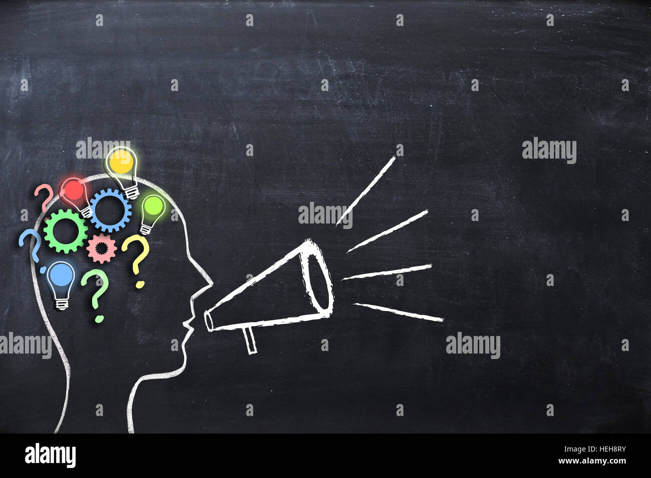 Coaching concept – knowledge and ideas sharing with human head shape and megaphone or bullhorn on blackboard Stock Photo