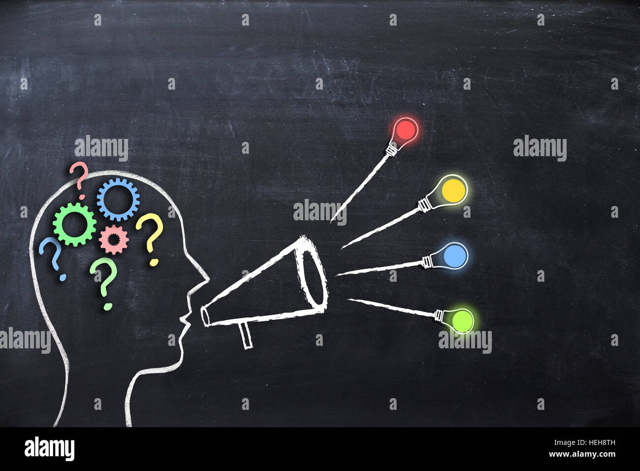 Human head shape with gears and question marks suggesting leadership or coaching concept Stock Photo