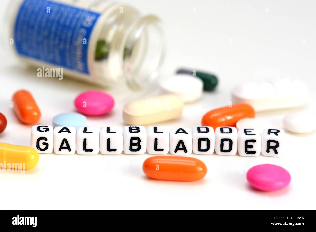 Gallbladder problems concept with colorful drugs out of container and gallbladder word from white cubes Stock Photo