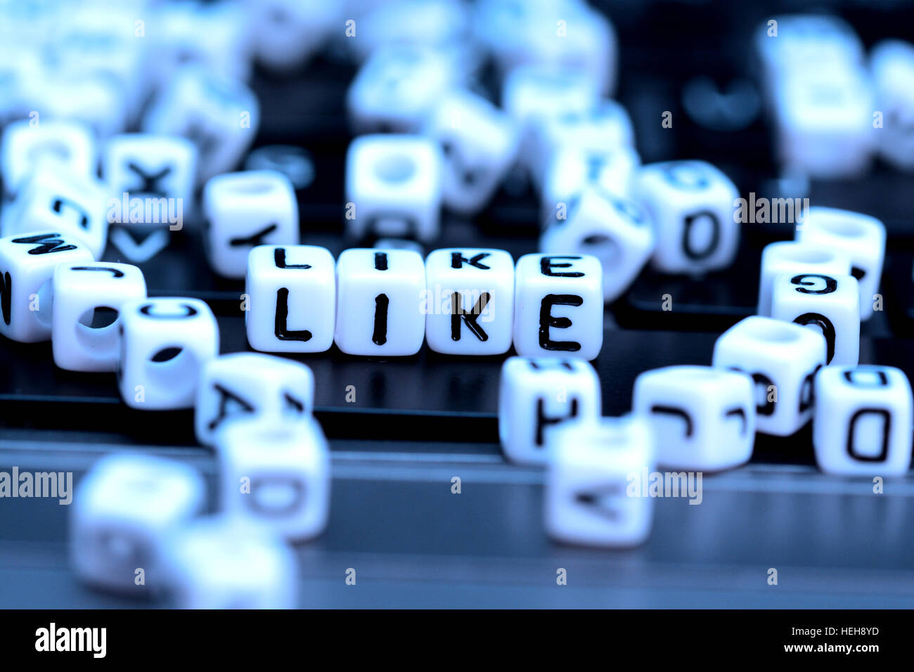Close-up of Like word from white cubes on notebook Stock Photo