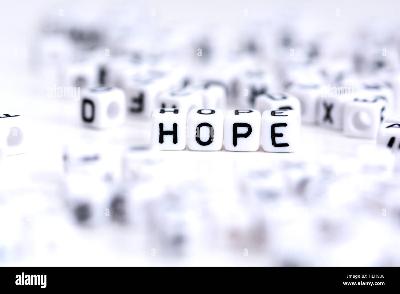 Hope word made from plastic alphabet blocks, stands in white background. Stock Photo