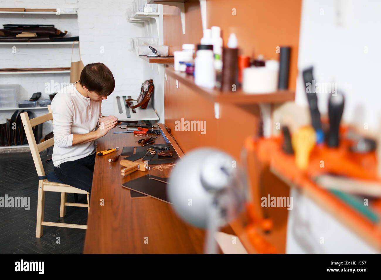 Leather Tanner Rack Young tanner working with leather pieces in his workroom Stock Photo ...
