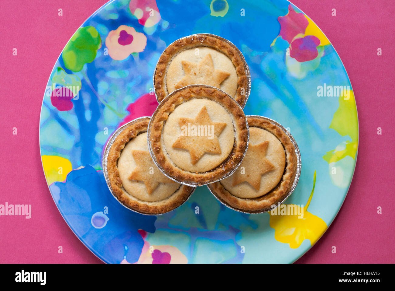 close up of mince pies with stars on, on colourful plate ready for ...