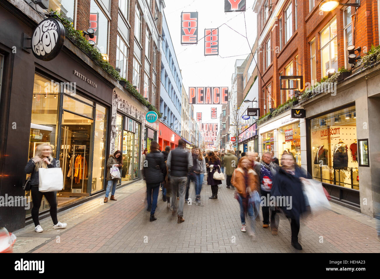 People Christmas shopping in motion blur on Carnaby Street, London. In ...