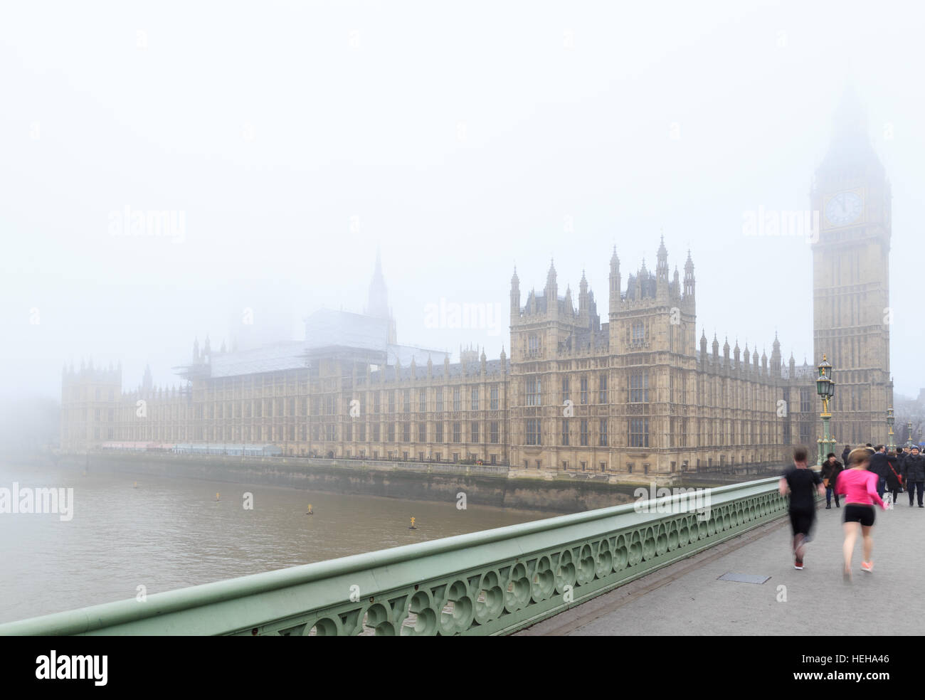 Joggers running over Westminster Bridge, near Big Ben, London. In