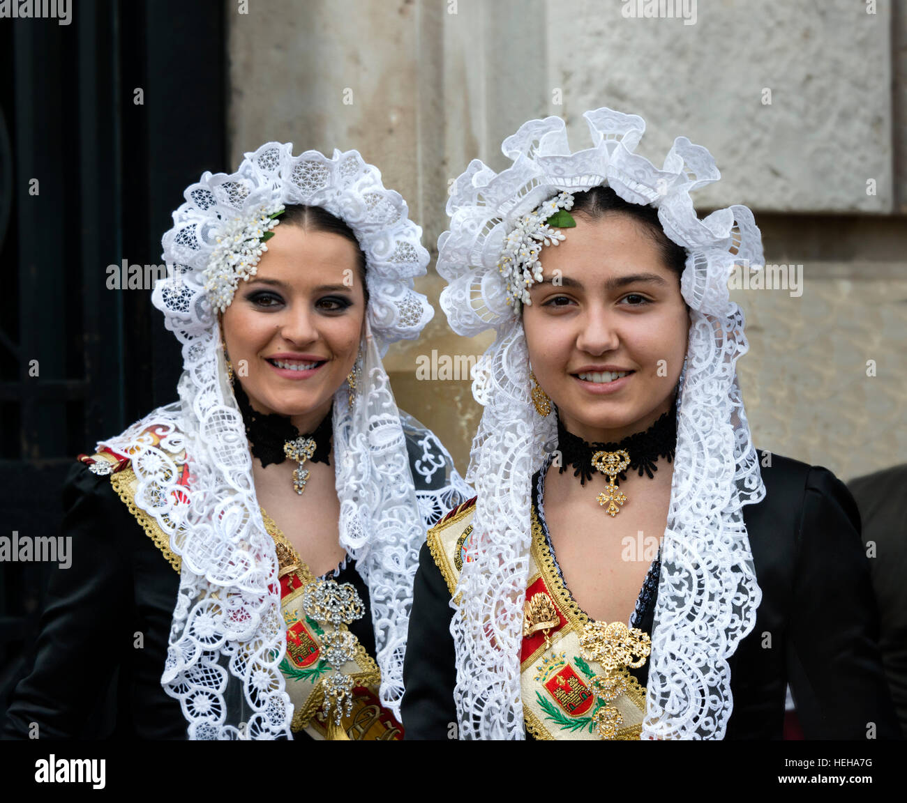 Spanish Girls  in Traditional Costume including lace mantilla  veil or shawl during las Fallas or Falles festival in Valencia Spain Stock Photo