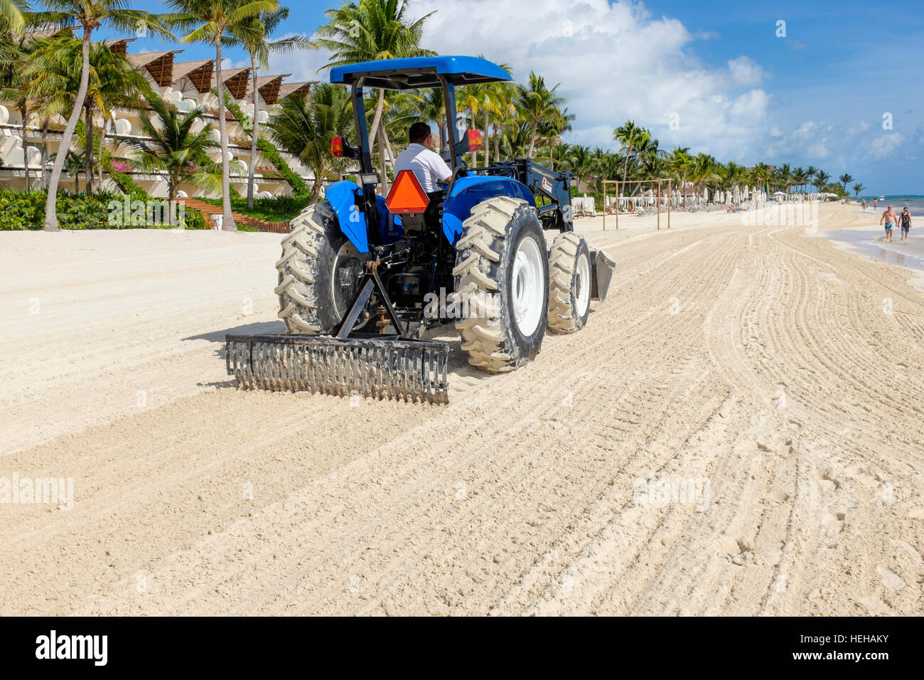 Tractor raking a beach at Playa Del Carmen, near Cancun, Mexico to