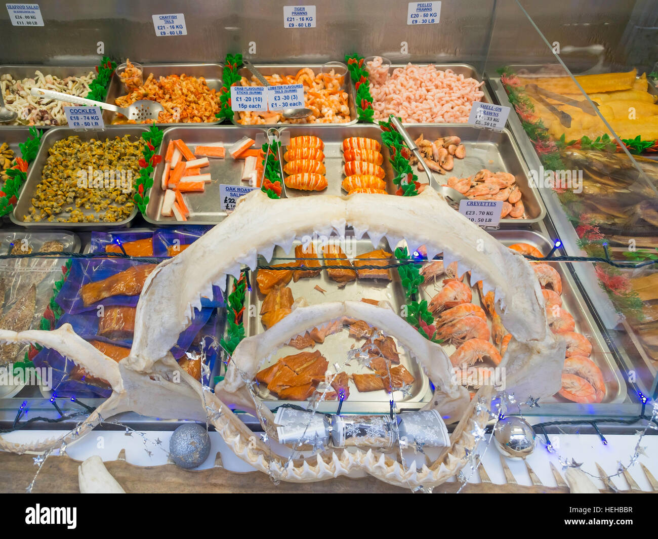 Fish shop window in Whitby decorated with Sharks Jaw Bones displaying several kinds of sea food with December 2016 price tags Stock Photo