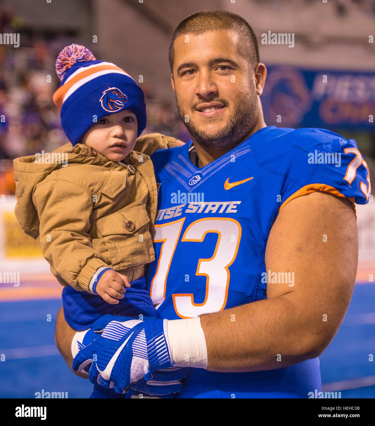 Boise State Football Game, Offensive lineman Travis Averill holding young son during Senior Day. Boise, Idaho, 2016 Stock Photo