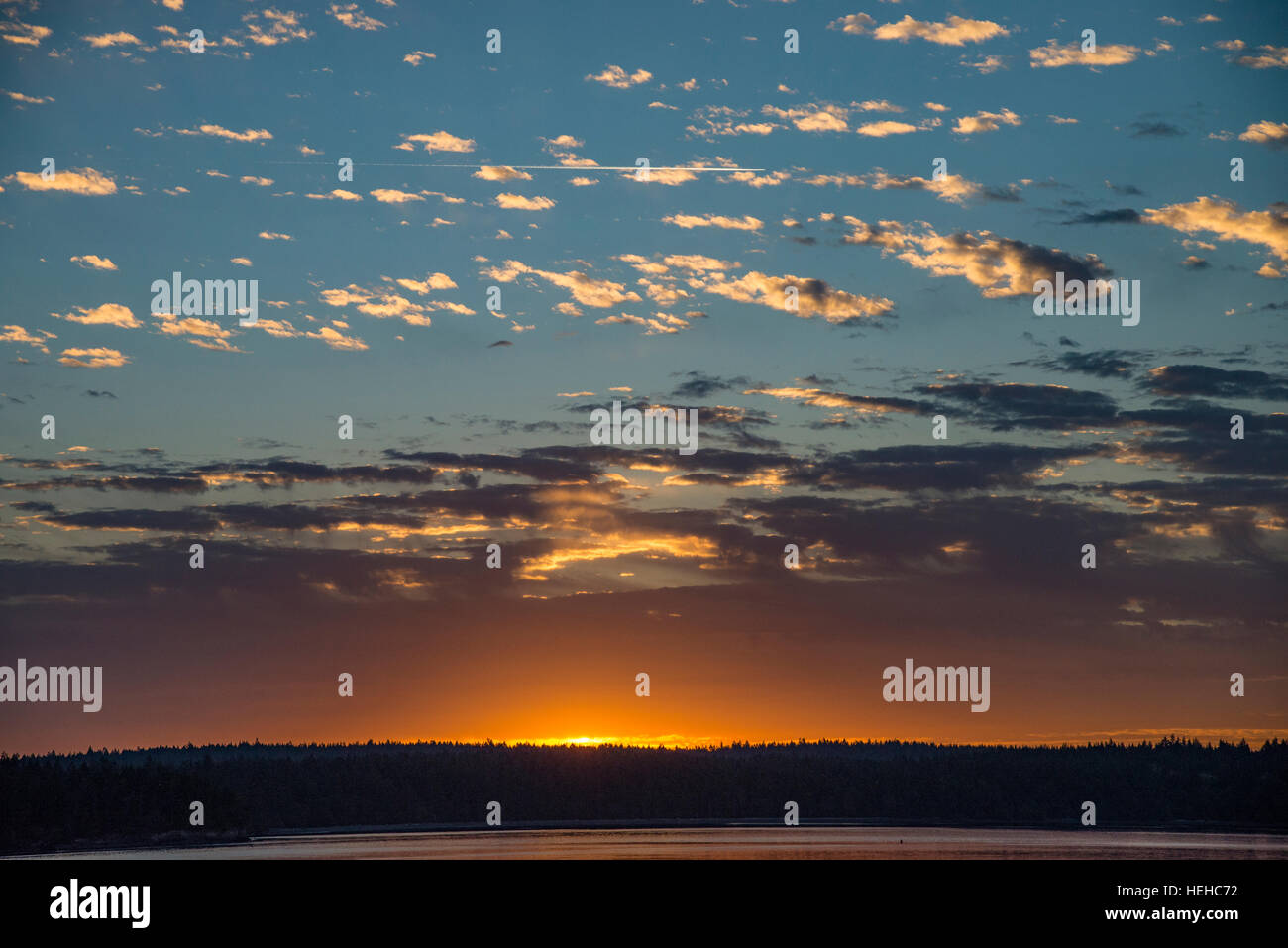 Sunrise with fish scale clouds over Squaxin Island on the Puget Sound, Washington, USA Stock Photo